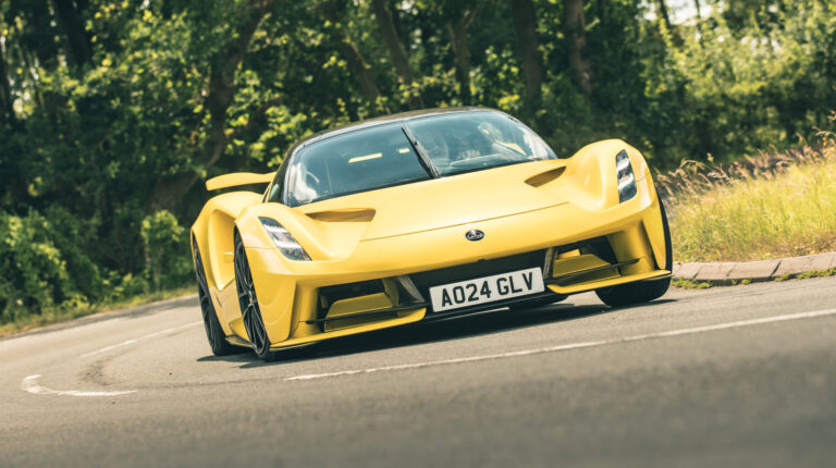 A yellow Lotus Evija being put through its paces as part of a test and development program on a quiet rural road